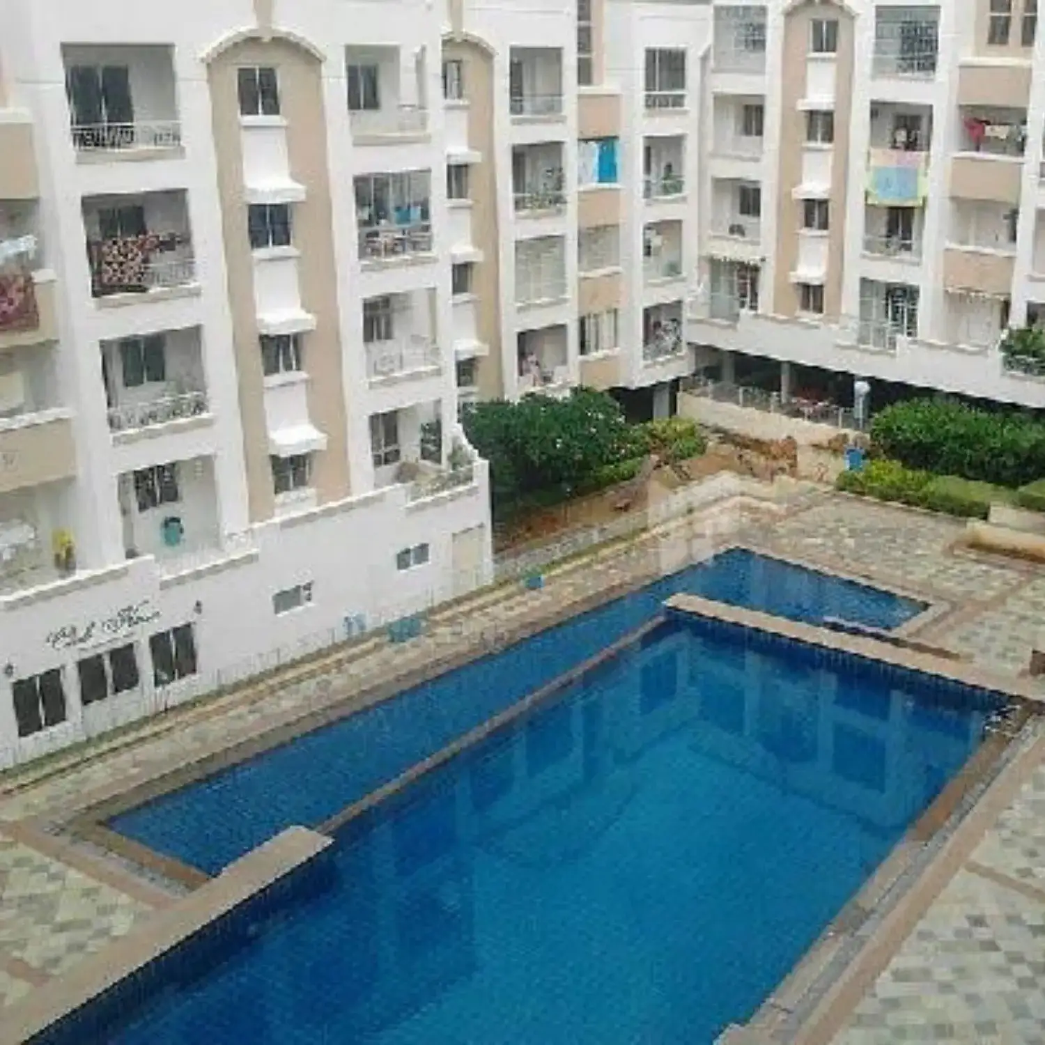 BTL activation setup by BrandLand at a residential apartment complex featuring poolside branding and promotional installation.