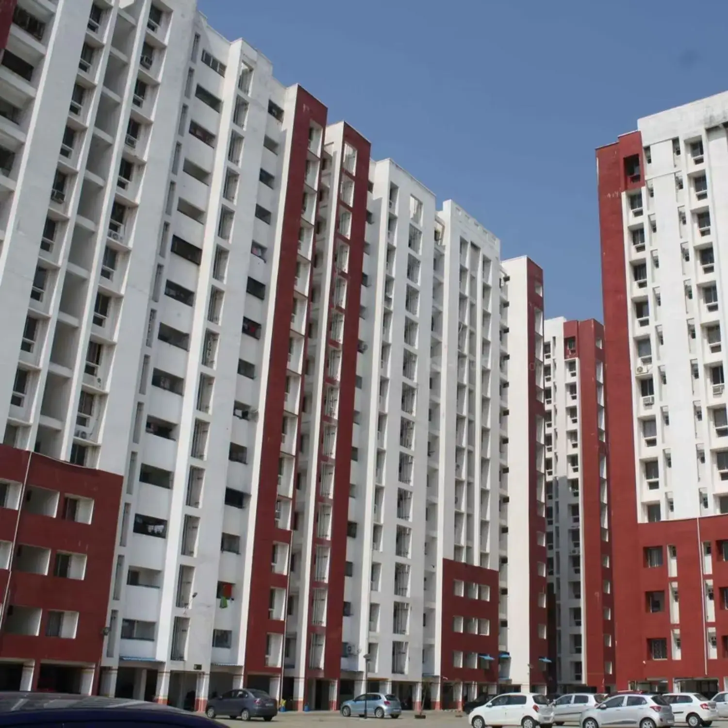 BTL activation setup by BrandLand featuring a high-rise residential backdrop with bold red and white branding elements.