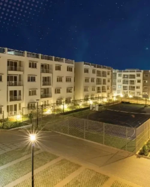 Evening view of a residential courtyard illuminated with warm lighting during a BTL activation event by BrandLand .